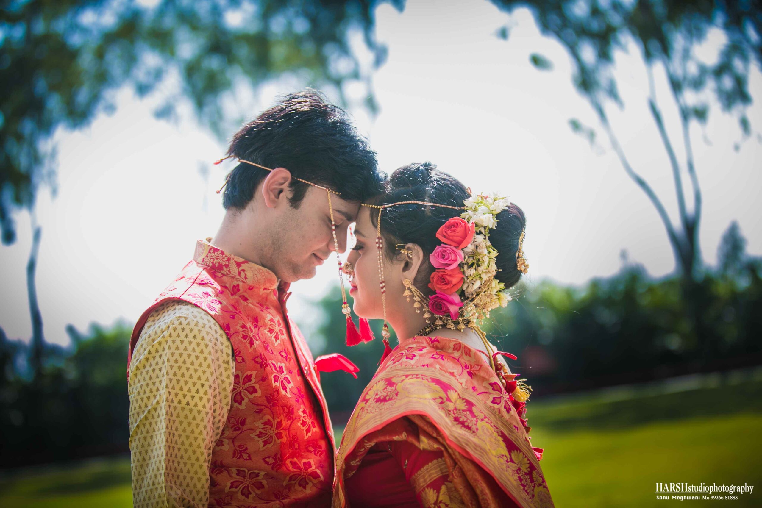 Candid Wedding Photography Indore - A bride and groom sharing a heartfelt moment amidst nature's beauty.